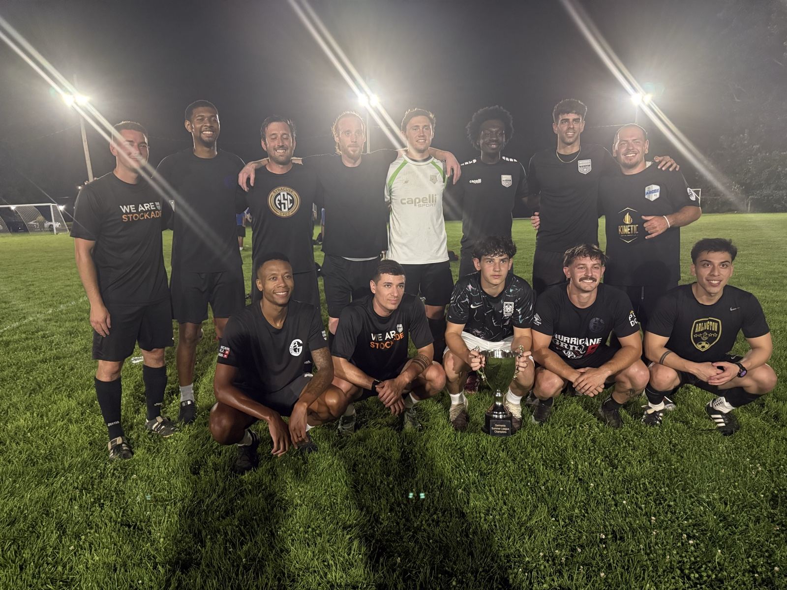 ABC, 2026 Germania Summer League champions, posing with the trophy under the lights on Championship Night at Germania, September 9, 2026