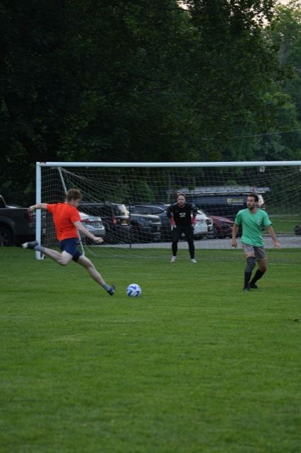 A player in orange lines up a shot as the goalkeeper gets set, Germania, June 2025