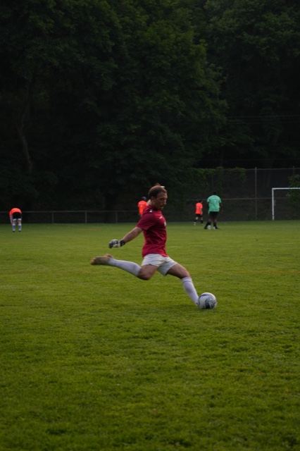 A goalkeeper in red takes a goal kick at Germania, June 2025
