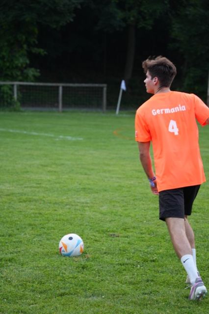 Number 4 in orange steps up to a free kick, June 2025