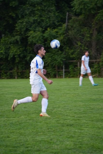 A player in white watches a high ball drop at Germania, June 2025